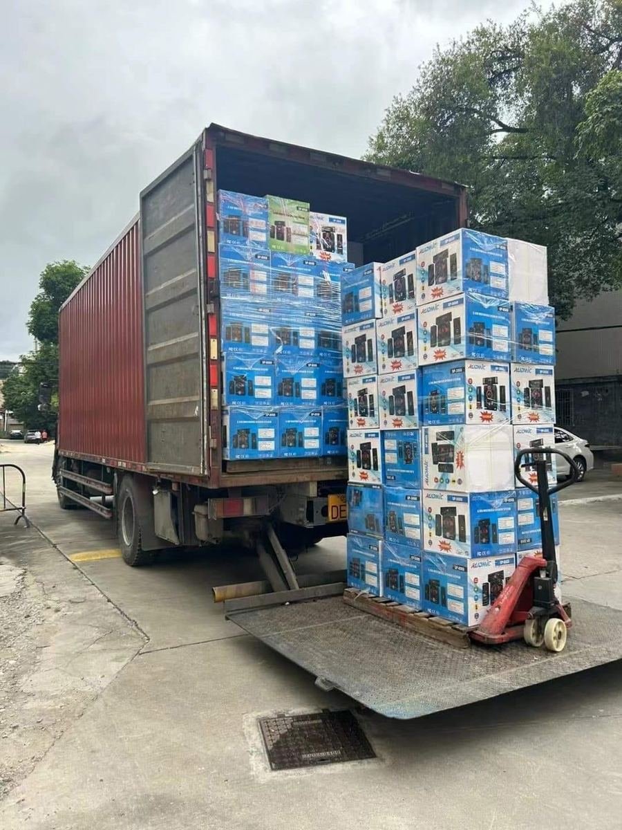 Branded client cartons stacked on a truck tail-lift for export