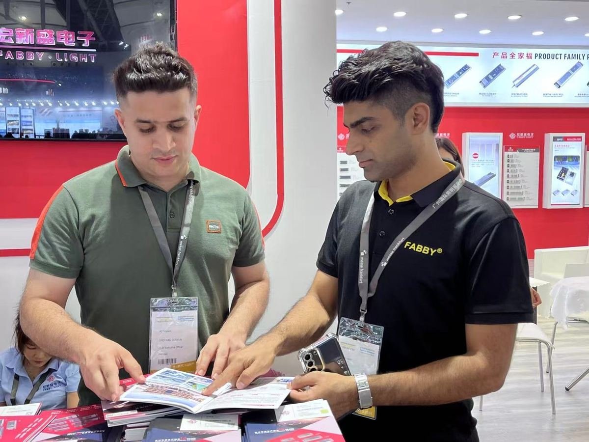 Our team reviewing product catalogues with an exhibitor at a China trade show