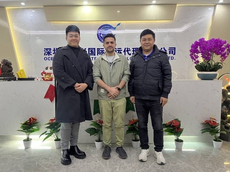 Our founder with two partners at a freight-forwarding company office